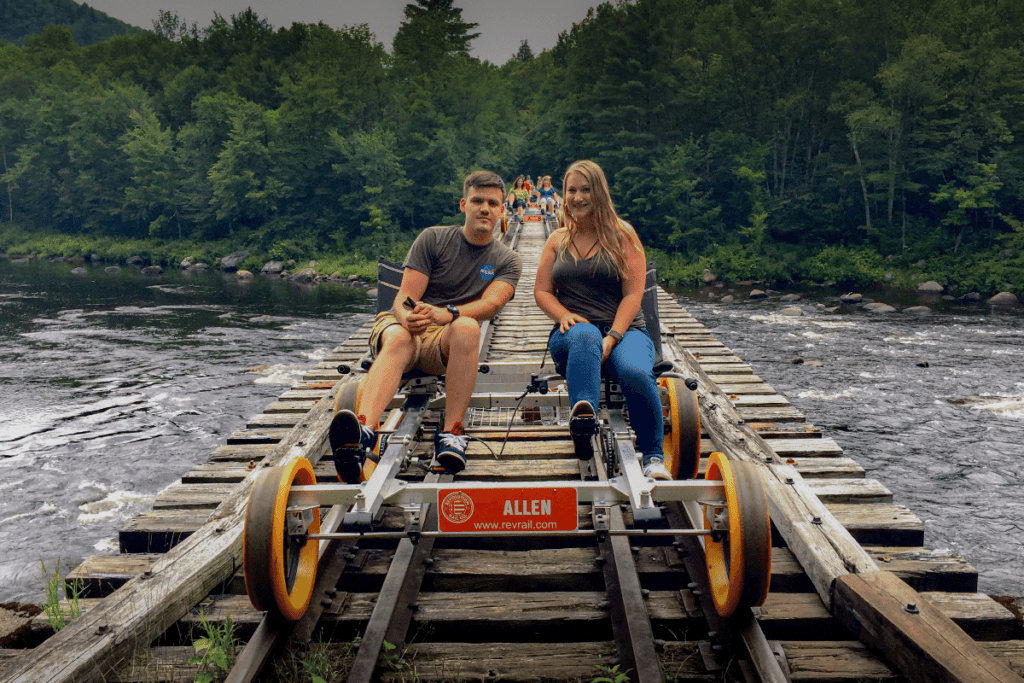 Couple on rail bikes in Adirondack Mountains Revolution Rail