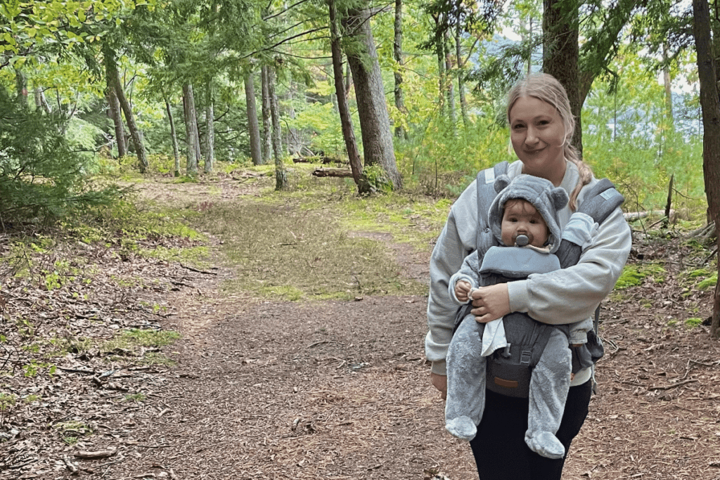 Mother and daughter in woods hiking, posing towards camera for photo