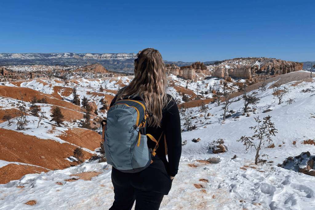 hiker looking over snowy Bryce Canyon national park in Winter